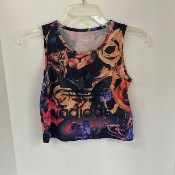 R56- “Adidas” crop tank top that is a floral print with “Adidas” logo on front.